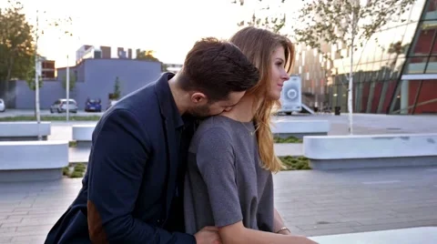 Couple  sitting on a bench and arguing. Girl is mad at her boyfriend Stock Footage 55891507