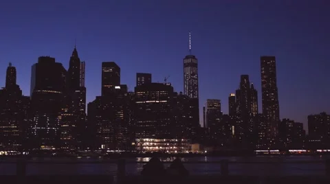 Couple sitting on the bench looking at NYC skyline Stock Footage 62200470