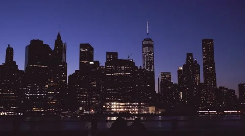 Couple sitting on the bench looking at NYC skyline Stock Footage 62200474