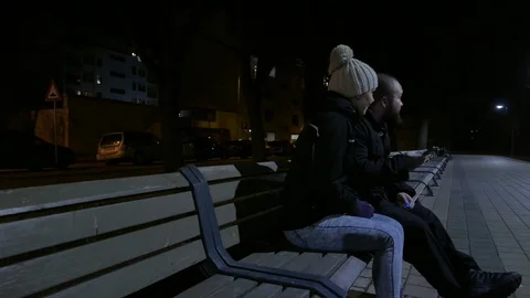 Couple sitting on the bench at night Stock Footage 73683348