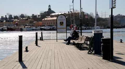 Couple sitting on a bench at the pier Stock Footage 41469487