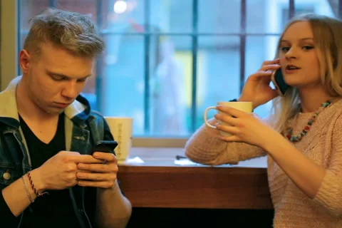 Couple sitting in the cafe and using modern technology 스톡 동영상 49463745