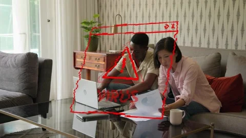 Couple sitting on couch sorting finance bills, red virus warning flashing laptop Stock Footage 333233797