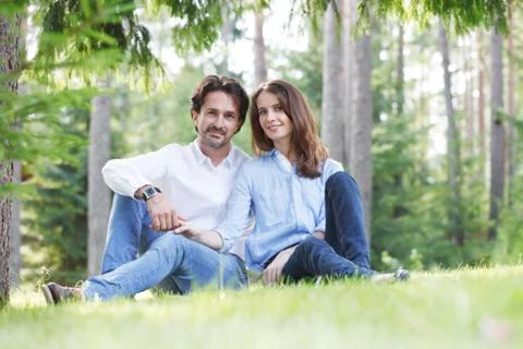 Couple sitting on grass Stock Photos
