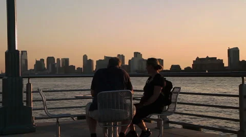 Couple sitting at the Hudson river Stock Footage 1064776