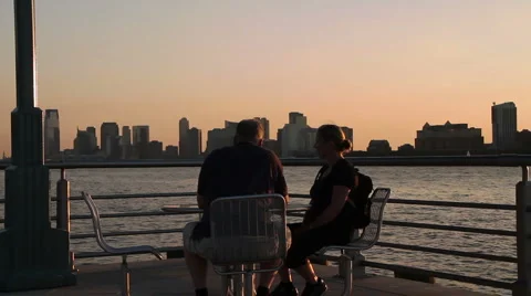 Couple sitting at the Hudson river Stock Footage 1064785