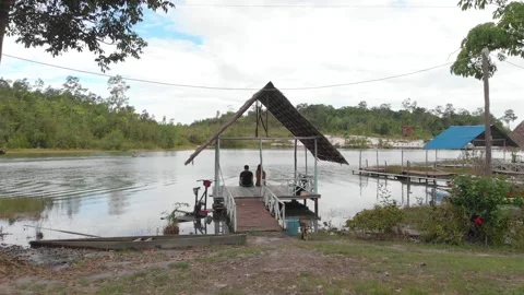 Couple Sitting By Lake Stock Footage 157091993