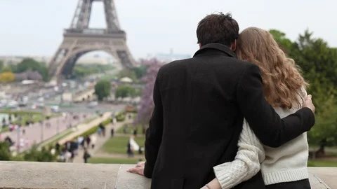 Couple sitting near Eiffel tower in Paris, France Stock Footage 98093960