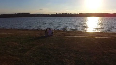 Couple sitting on the pier at sunset. Shooting with quadrocopters. Dron. dji Stock Footage 67486347