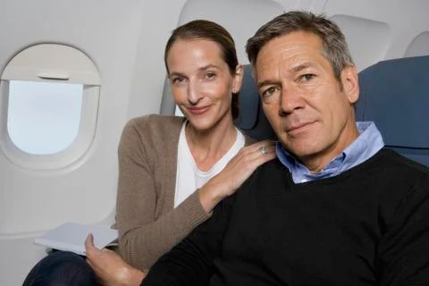 A couple sitting on a plane Stock Photos