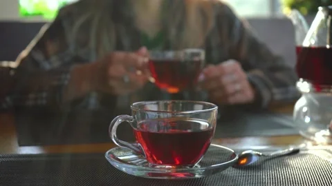 Couple is sitting in a restaurant and drinking red tea Stockbeeldmateriaal 140653743