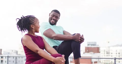 Couple sitting rooftop bench man releasing leg and standing, woman following Stock Footage 340654527
