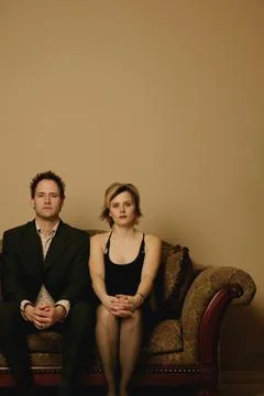 Couple Sitting Side By Side Stock Photos