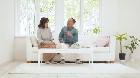 Couple Sitting on the Sofa 库存影片 332777063