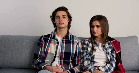 Couple sitting on sofa, giving presents to each othes and smiling in valentine Stock-Footage 124905973