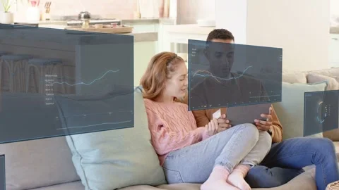 Couple sitting sofa man tapping tablet making sliding AR budget charts planning Stock Footage 337905045