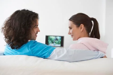 Couple Sitting On Sofa Stock Photos