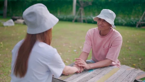 Couple sitting on a table on the balcony, bonding, trusting or supporting love Stock Footage 265142465