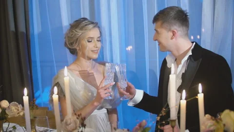 Couple sitting at the table with glasses in their hands Stock Footage 126524779