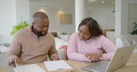 Couple sitting at table, man pointing line and signing forms with blue pen, Stock Footage 340750870