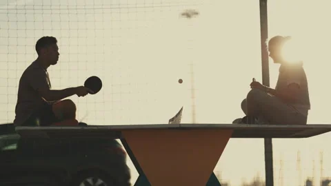 Couple sitting on table playing ping pong Stock Footage 332507405