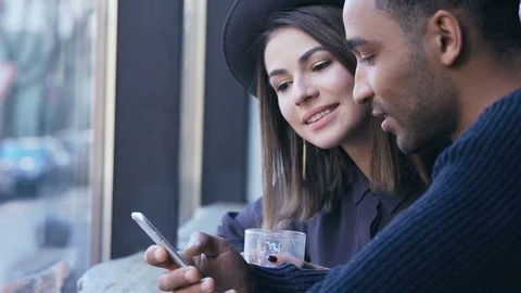 Couple sitting at table using mobile phone Stock Footage 72278558