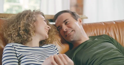 Couple sitting together on couch Stock Footage 114116675