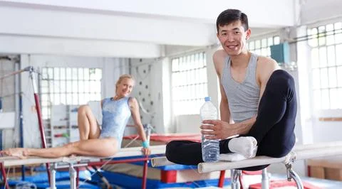 Couple sitting on top parallel bars Stock-Fotos