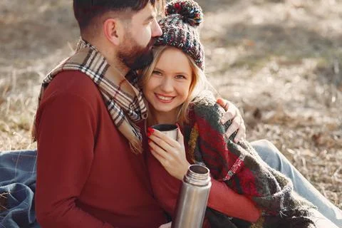 Couple sitting by the tree in a spring forest Stock Photos