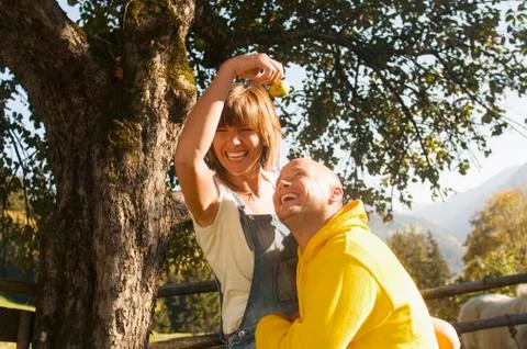 Couple sitting under tree Stock Photos