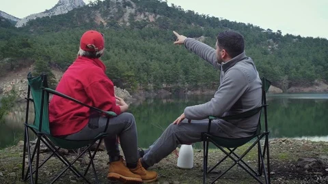 Couple sitting by waterside 1 Video stock 105011369
