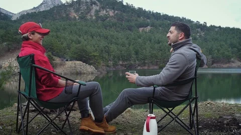 Couple sitting by waterside 3 Video stock 105012461