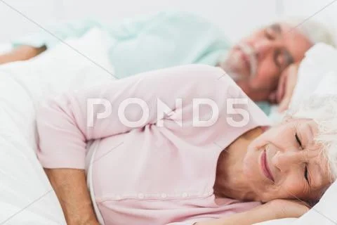 Couple sleeping in bed Stock Photos