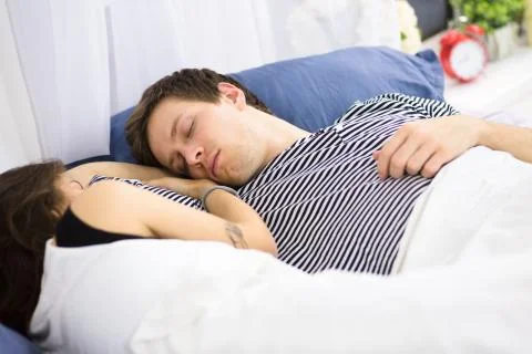 Couple sleeping on bed Stock Photos