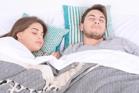 Couple sleeping in bed. Stock Photos