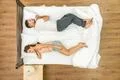 The couple sleeping on the bed. View from above Photo