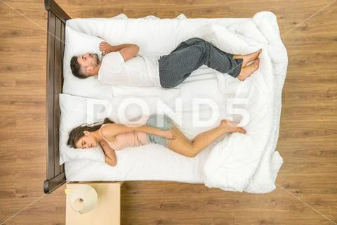 The couple sleeping on the bed. View from above Stock Photos