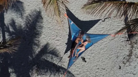 Couple Sleeping on Hammock on Tropical Beach Birds Eye Drone Shot Stock Footage 88414902
