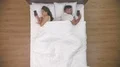 The couple sleeping with phones in the bed. view from above 4k or 4k+ Resolution
