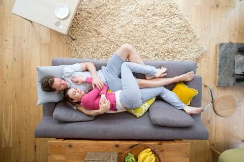 Couple Sleeping on Sofa Фото