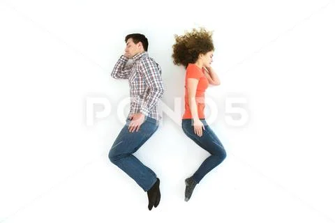 The couple sleeping on the white floor. View from above Stock Photos