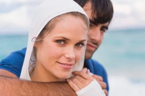 Couple smiling on the beach Stock Photos