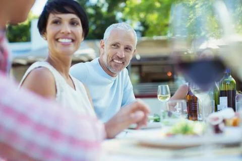 Couple smiling at table outdoors Stock Photos