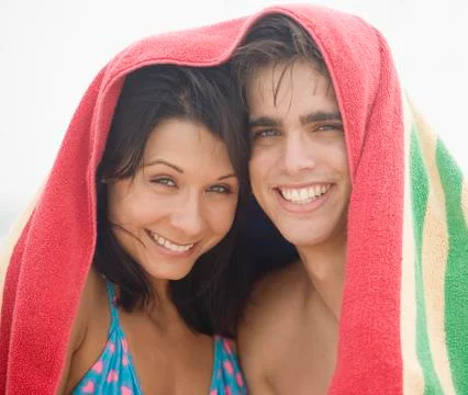 Couple smiling with towel over their heads Fotos Stock