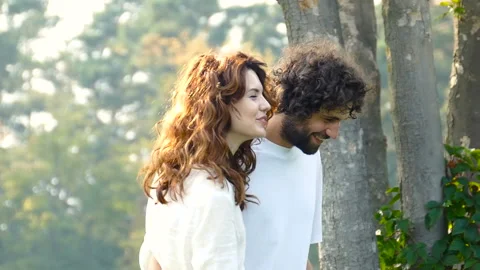 Couple smiling, walking and talking at the park. Video stock 94563329
