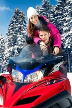 Couple on snowmobile Stock Photos