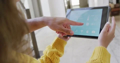 Couple spending time at home using tablet with smart home interface Stock Footage 343238102