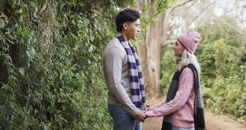 Couple spotting each other, walking on dirt path and clasping gloved hands, Stock Footage 341320102