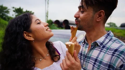 Couple stand closely having cone on their date outdoor Stock-Footage 300351565
