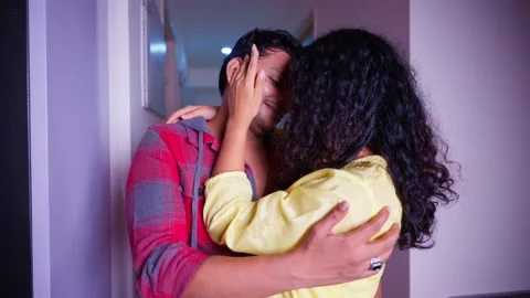 Couple stand closely inside room sharing tender moment Stock Footage 297243674